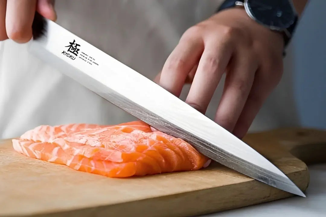close up of a sushi being sliced with a yanagiba knife